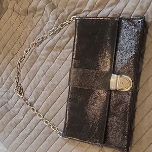 Shiny black patent leather clutch or silver chain shoulder bag